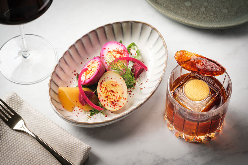 Serliana image of cocktail and deviled eggs